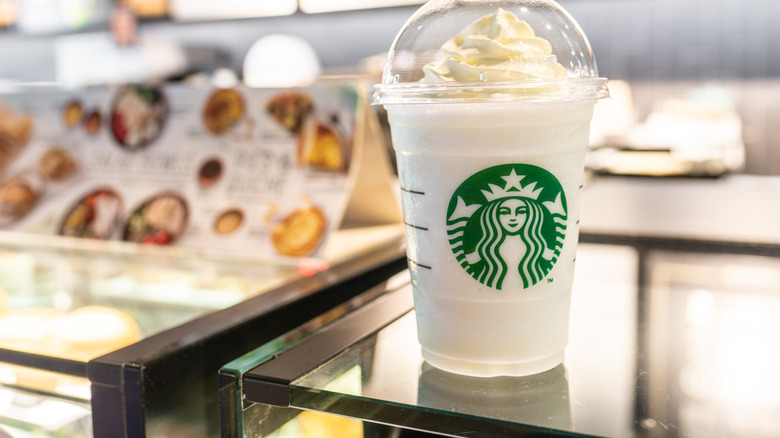 Vanilla frappuccino with whipped cream on table