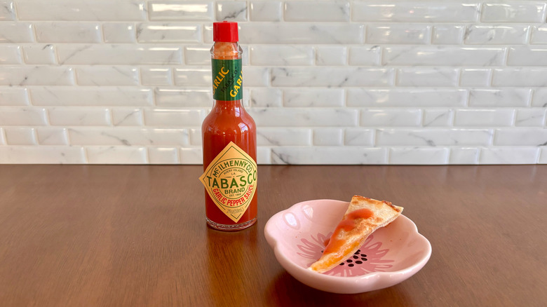 Tabasco garlic pepper sauce next to quesadilla slice