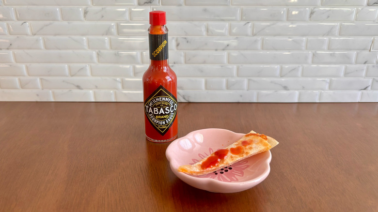 Tabasco Scorpion sauce next to quesadilla slice