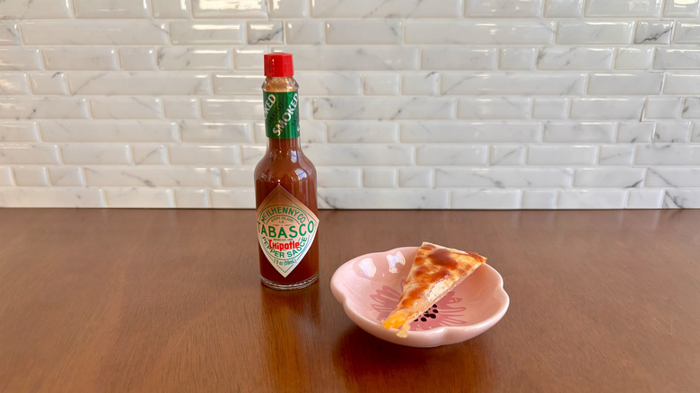 Tabasco Chipotle sauce bottle next to quesadilla slice