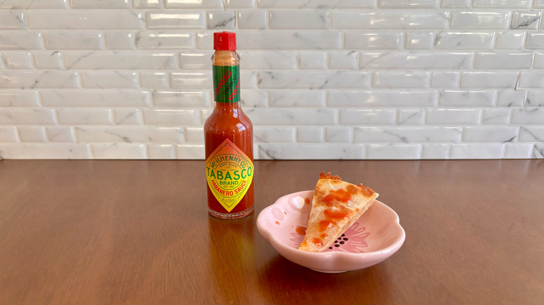 Tabasco Habanero sauce bottle next to quesadilla slice