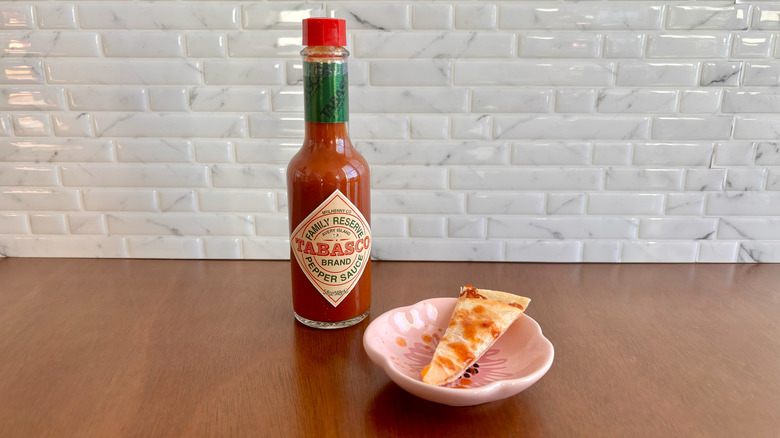 Tabasco's Family Reserve sauce bottle next to quesadilla slice