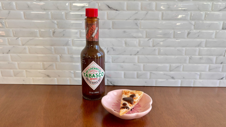 Tabasco Roasted Pepper sauce bottle next to quesadilla slice