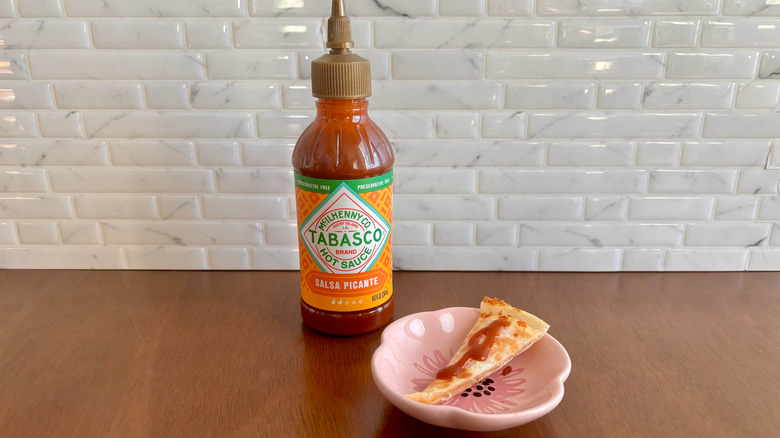 Tabasco Salsa Picante bottle next to quesadilla slice