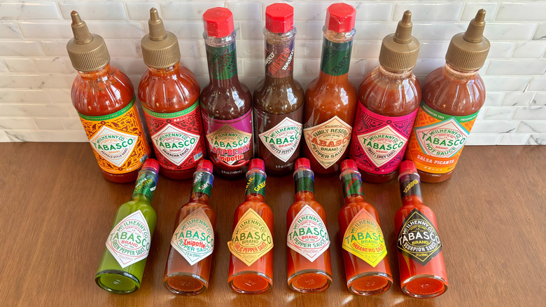 Various Tabasco hot sauce bottles on table