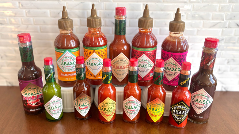 Various Tabasco hot sauce bottles on table