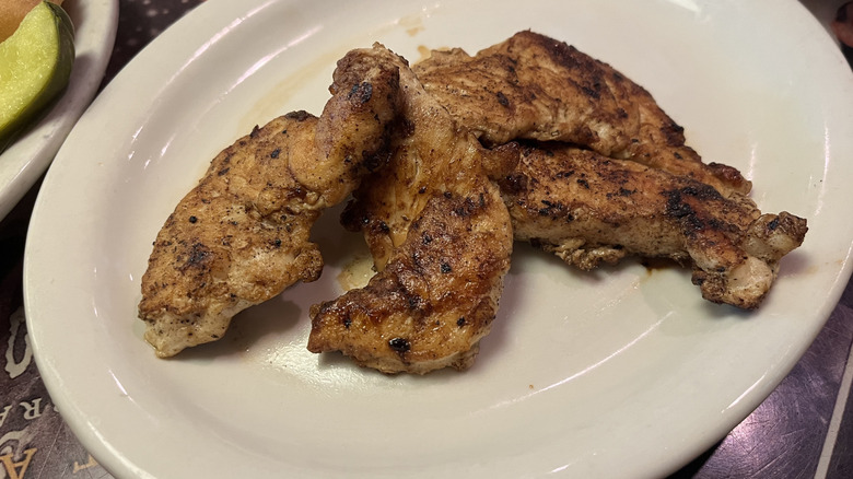 Grilled chicken pieces on a plate