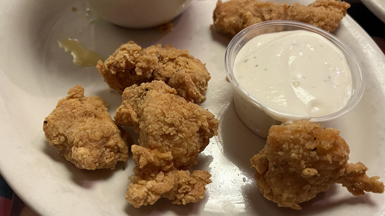 Small pieces of chicken with ranch on a plate