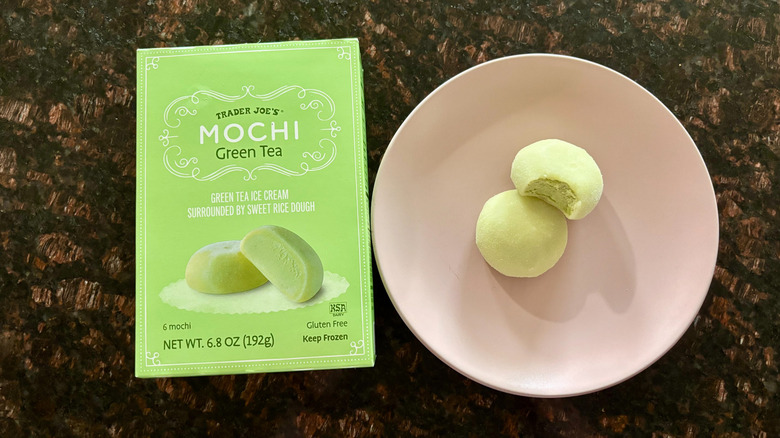 Trader Joe's green tea mochi box next to mochi on plate