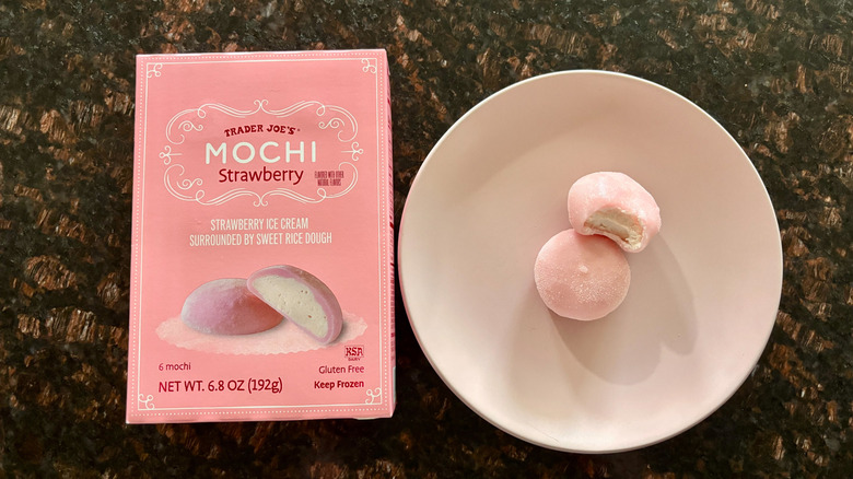 Trader Joe's strawberry mochi box next to mochi on plate