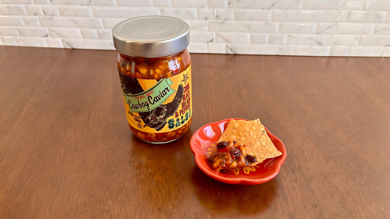 Trader Joe's cowboy caviar salsa next to chip on plate