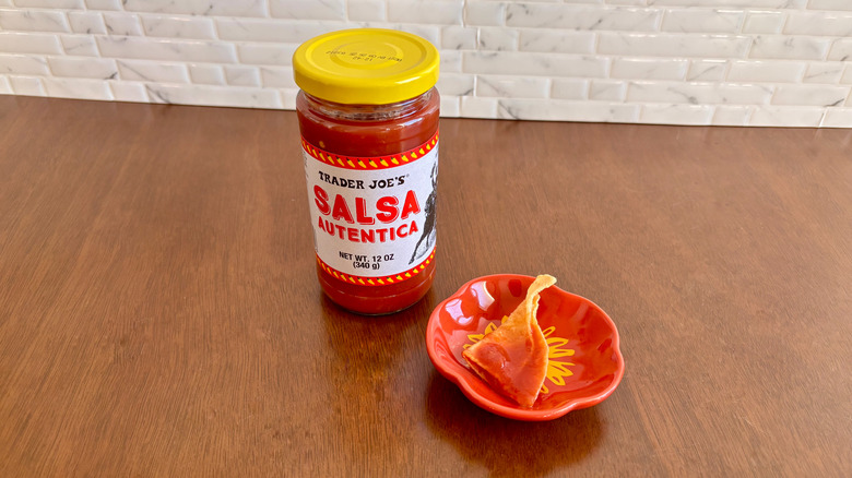 Trader Joe's salsa autentica next to chip on plate