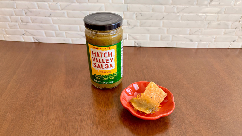 Trader Joe's hatch valley salsa next to chip on plate