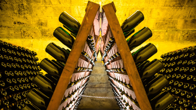 Champagne bottles aging in rack