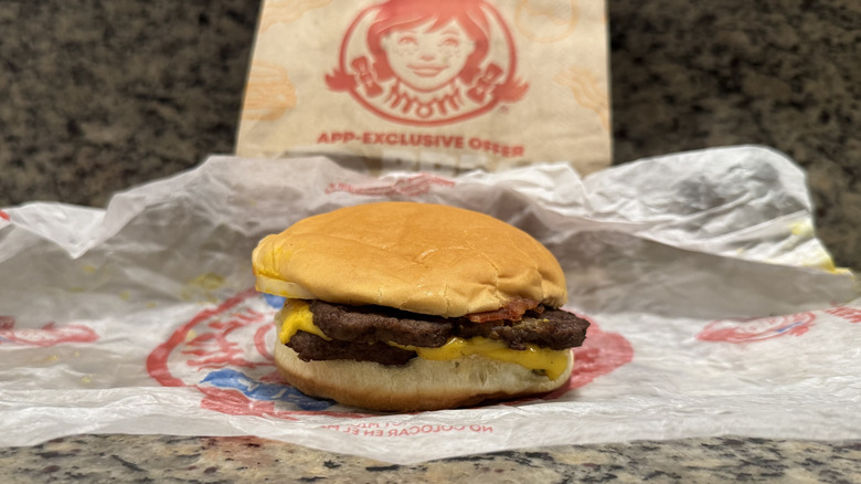Bacon Double Stack burger in Wendy's wrapper on counter