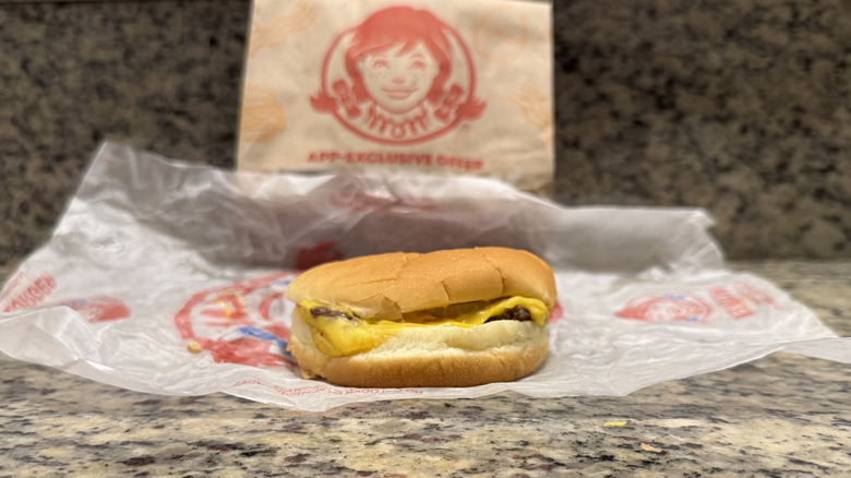 Jr. Cheeseburger in Wendy's wrapper on counter