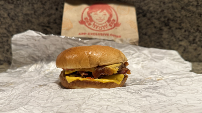 Son of Baconator burger in Wendy's wrapper on counter