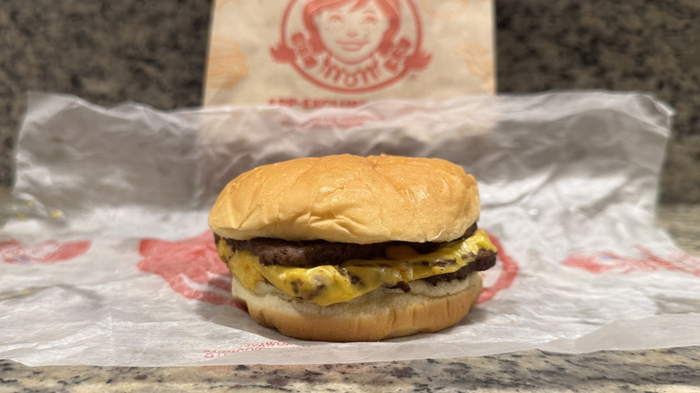 Double Stack burger in Wendy's wrapper on counter
