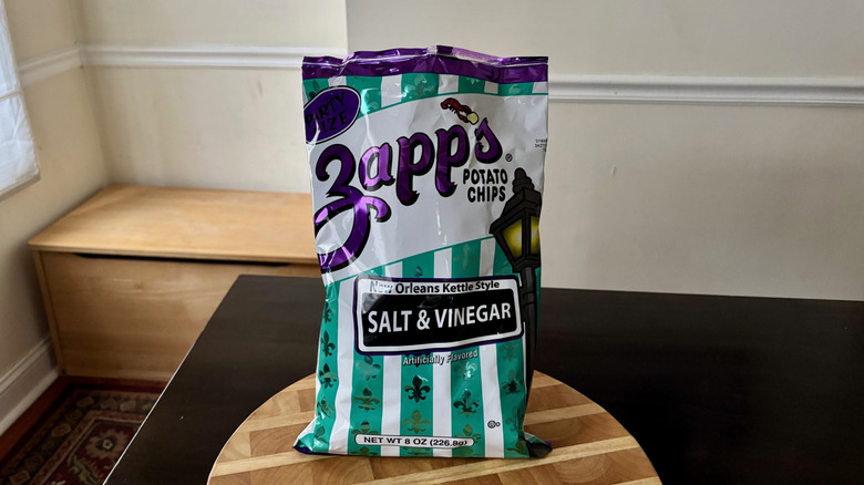 Bag of Zapp's Salt & Vinegar chips on wooden board