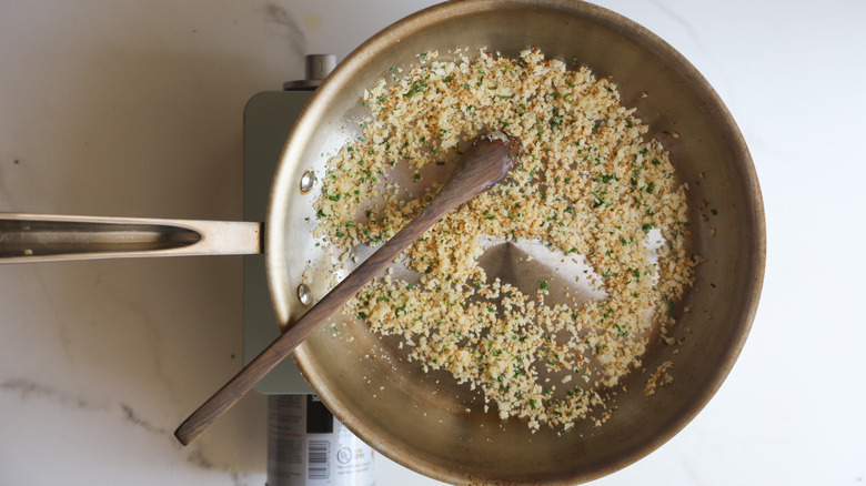 Toasted chive breadcrumbs in pan