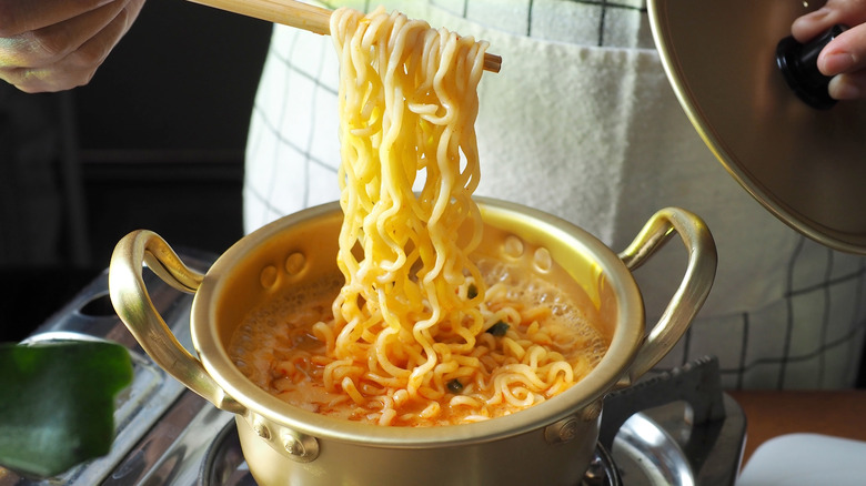 person cooking ramen