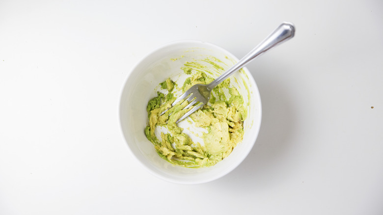 mashed avocado in white bowl