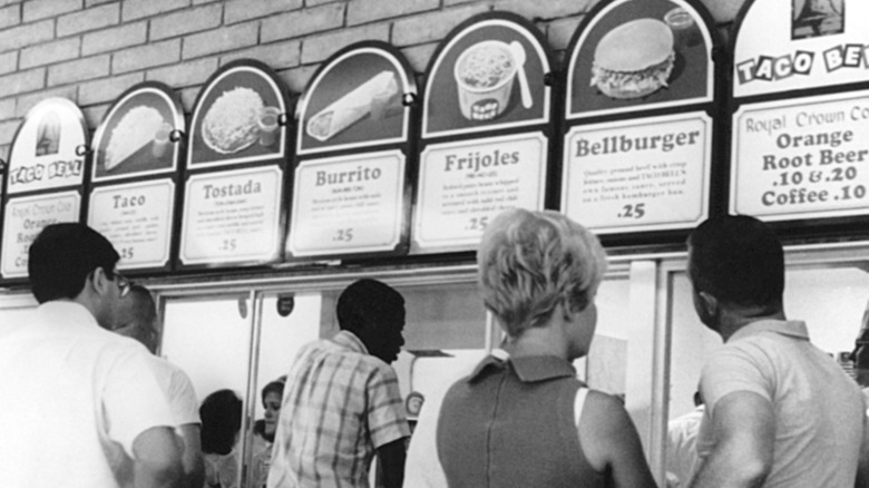 Vintage Taco Bell menu listing drink options as Royal Crown Cola, Orange, Root Beer, and coffee at 10 cents, 20 cents, and 10 cents each, respectively.