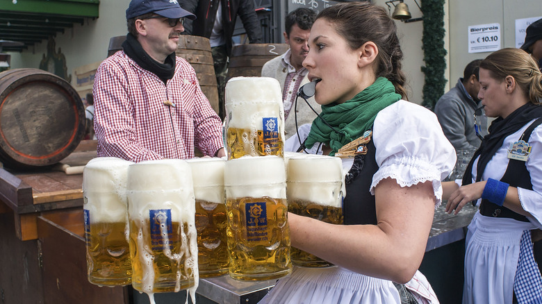 waitress carrying beer steins