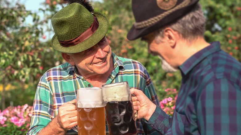 older Bavarian men clinking beers