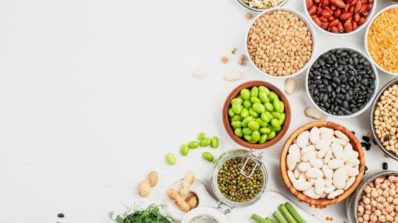 assorted fresh, sprouted and dried beans on table