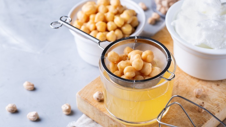 chickpea aquafaba drained into bowl