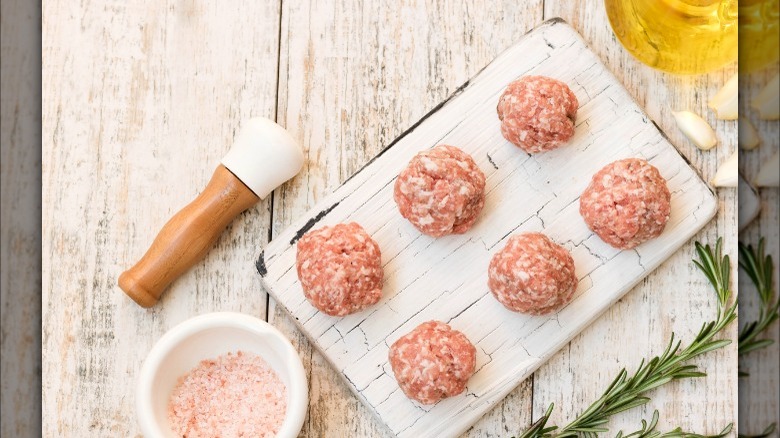 raw meatballs on a board