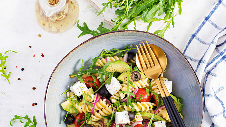 Arugula with black olives, red tomatoes and feta cheese