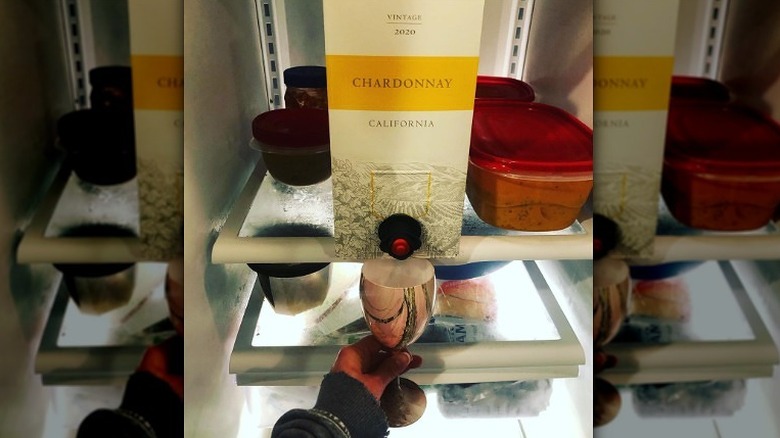 pouring boxed wine in fridge