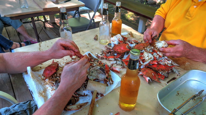 People eating crabs mallet beers