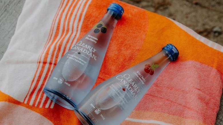 Two bottles on a beach towel