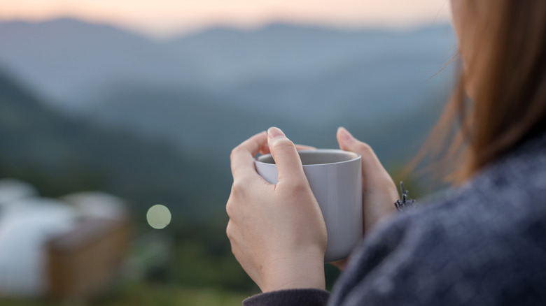 Woman holding coffee mug