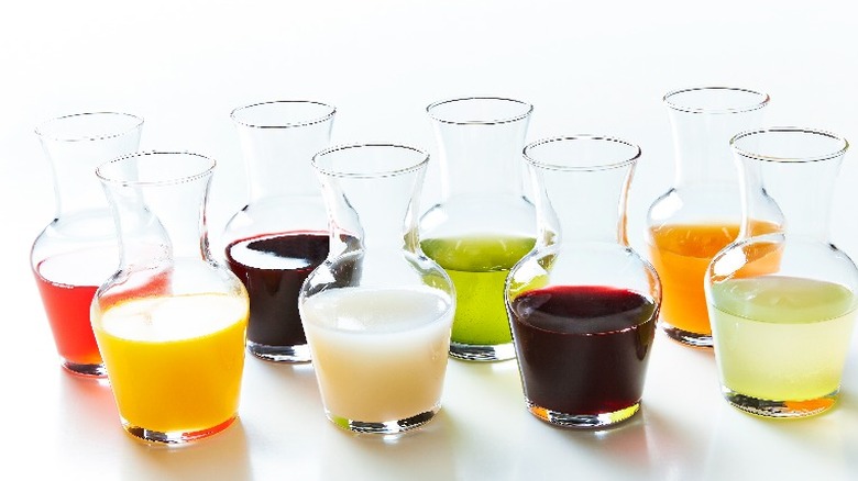 Several glass carafes of juices or wine