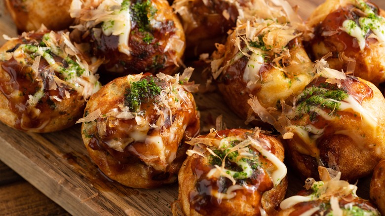 Row of takoyaki with toppings 