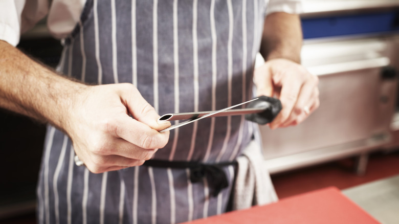 Chef honing a knife