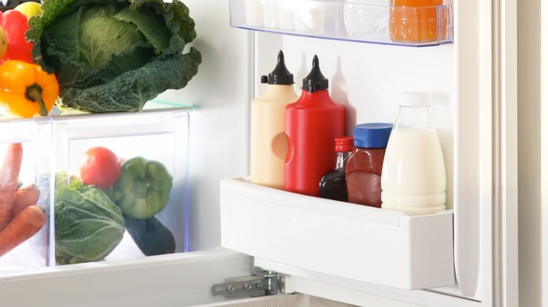 Open fridge with condiments