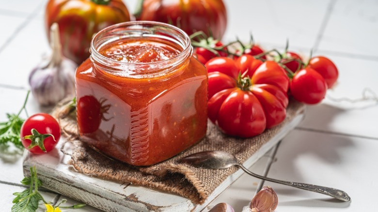 Jar of homemade ketchup on table