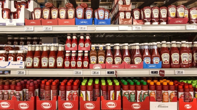 Supermarket shelves full of various ketchup