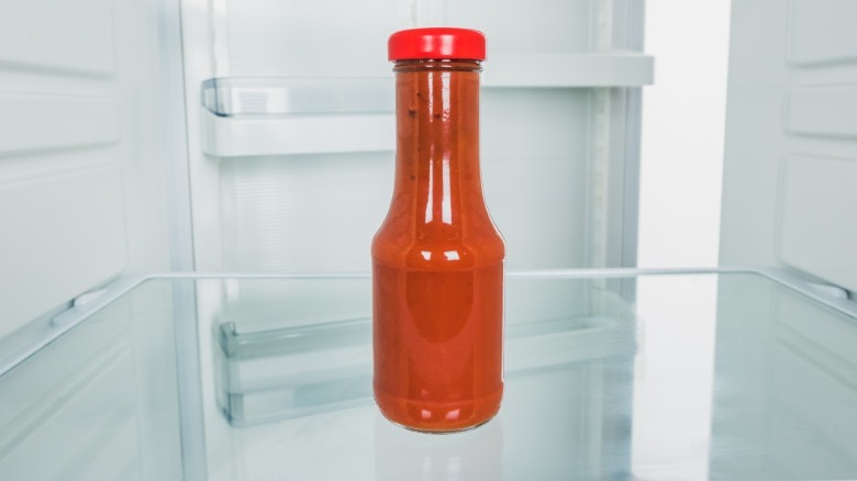 Bottle of ketchup in empty fridge