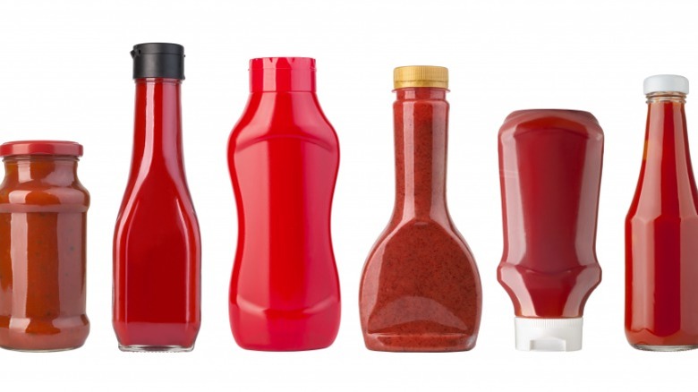 Various ketchup bottles on white background