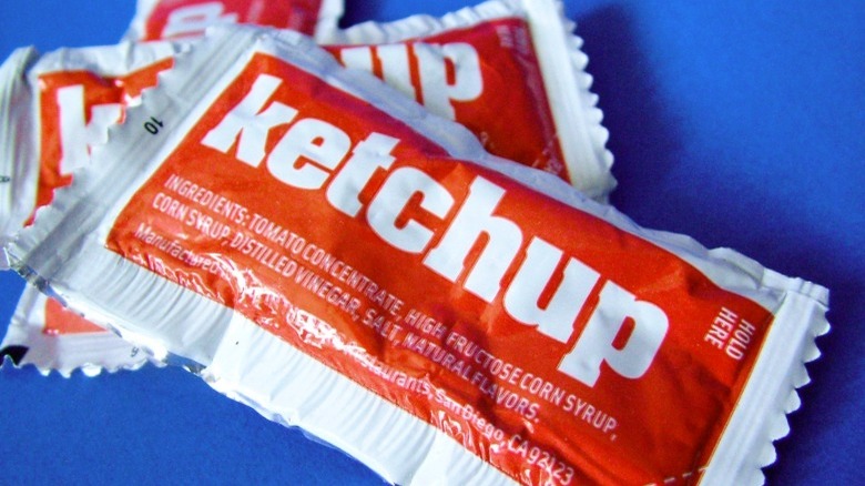 Ketchup packets on blue background