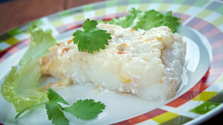lutefisk on a plate with herbs