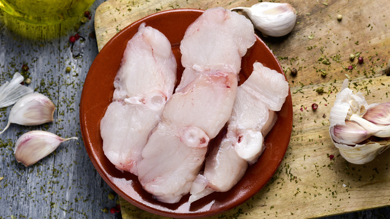Raw monkfish on plate