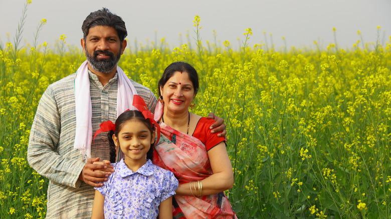 Family farmers in mustard field