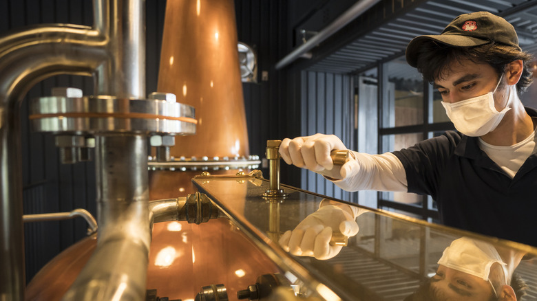 person working at whiskey distillery